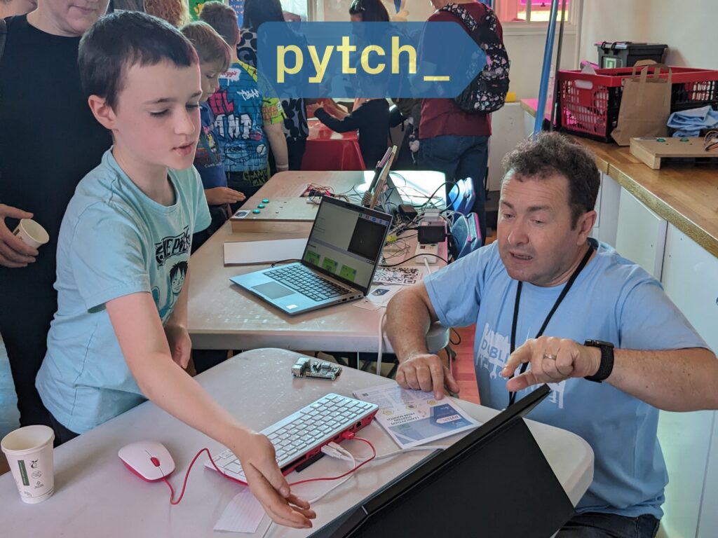 The Pytch principal investigator Glenn Strong presenting Pytch at Dublin Maker. A children is visible interacting with Pytch. On the top of the image the Pytch logo is visible.