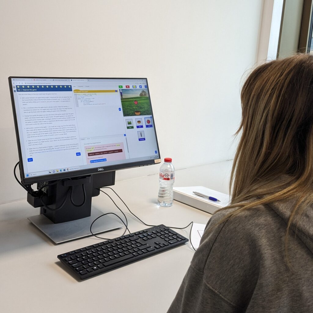 Photo showing a female student working with the new script by script Pytch editor.